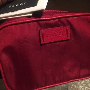 Gucci toiletry bag in a red color-way. Gently used. No stains. No flaws.